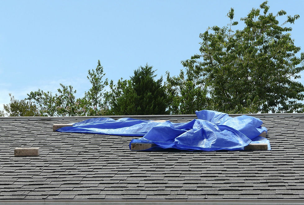 Temporary roof fix with tarps to prevent leaks until full repairs.