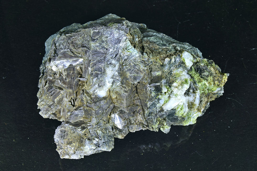 Ferroaxinite crystals on rock matrix