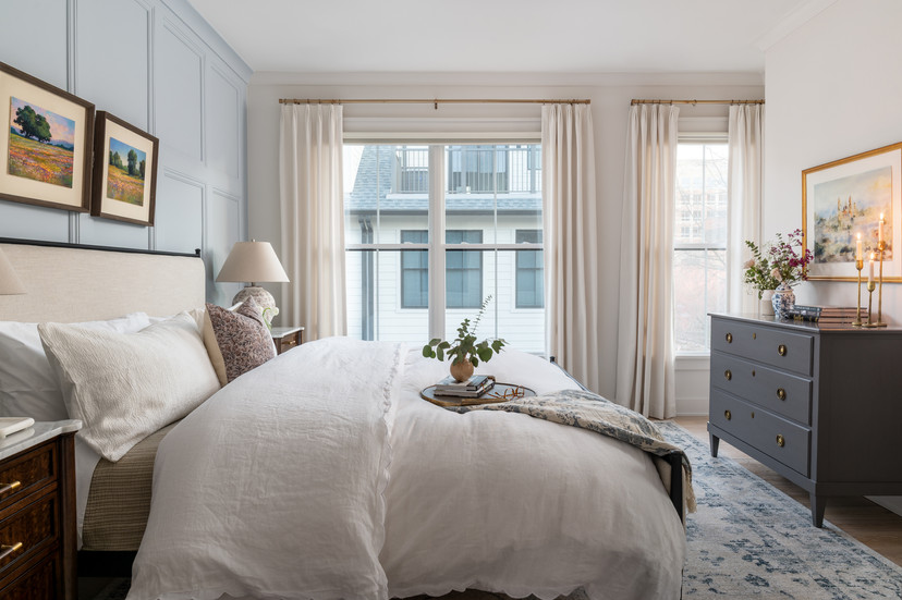 Layered, neutral bedroom.