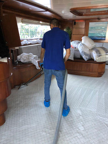 carpet cleaning technician cleaning carpet on a boat
