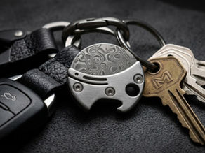A premium Damascus steel tiny knife for car keychain integration, displayed as a functional luxury accessory alongside a modern vehicle fob and high-end EDC gear.