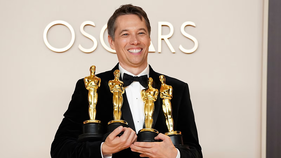 Sean Baker holding his Oscar trophies