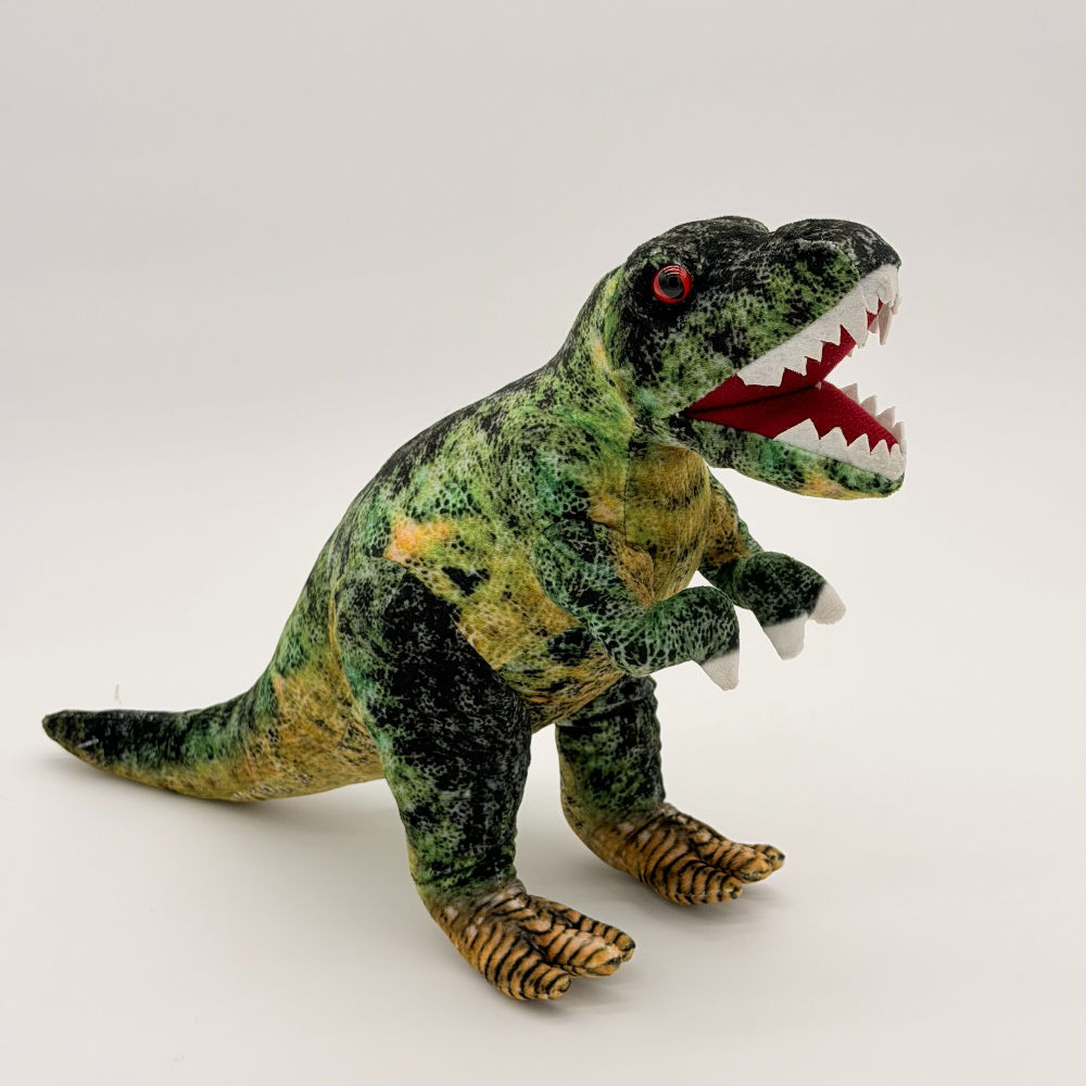 Front view Huggable Toys 25cm T-Rex plush toy with soft green, black, yellow mottled fabric, large white teeth and red eyes