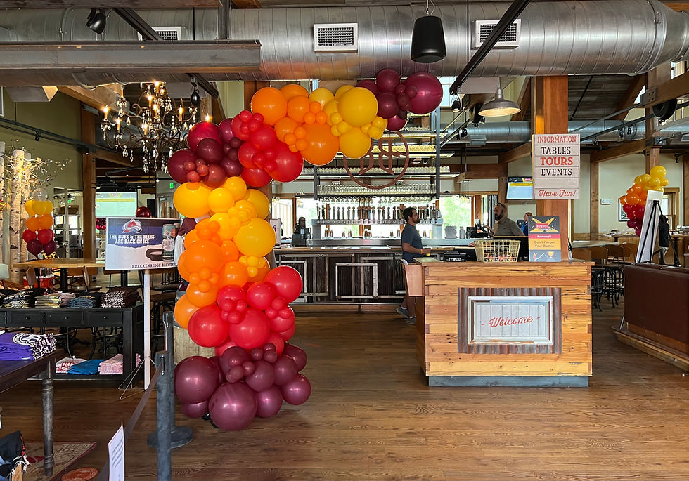 Custom balloon installation with branded color tones at PWC corporate event celebration