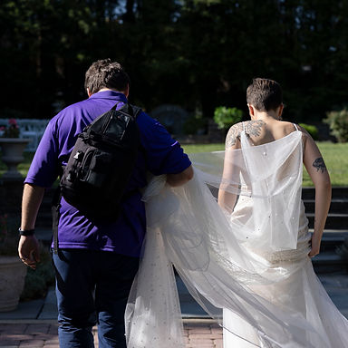 Justin from Still Poetry Photography helping a bride at a wedding