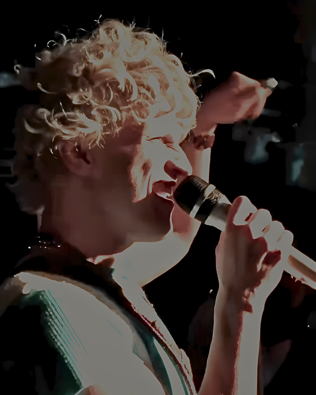 Oceana Dix singing into a microphone during a live performance