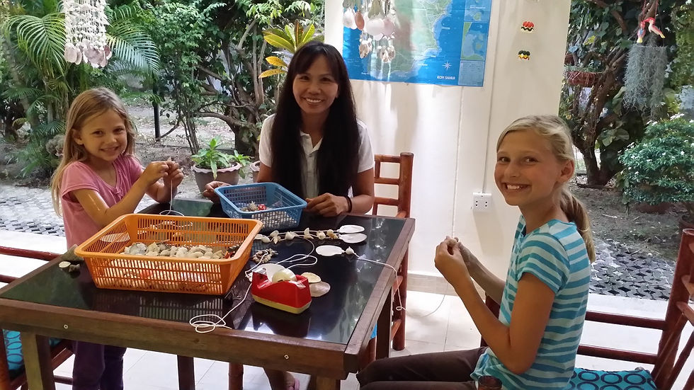 Making shell necklaces with our landlady