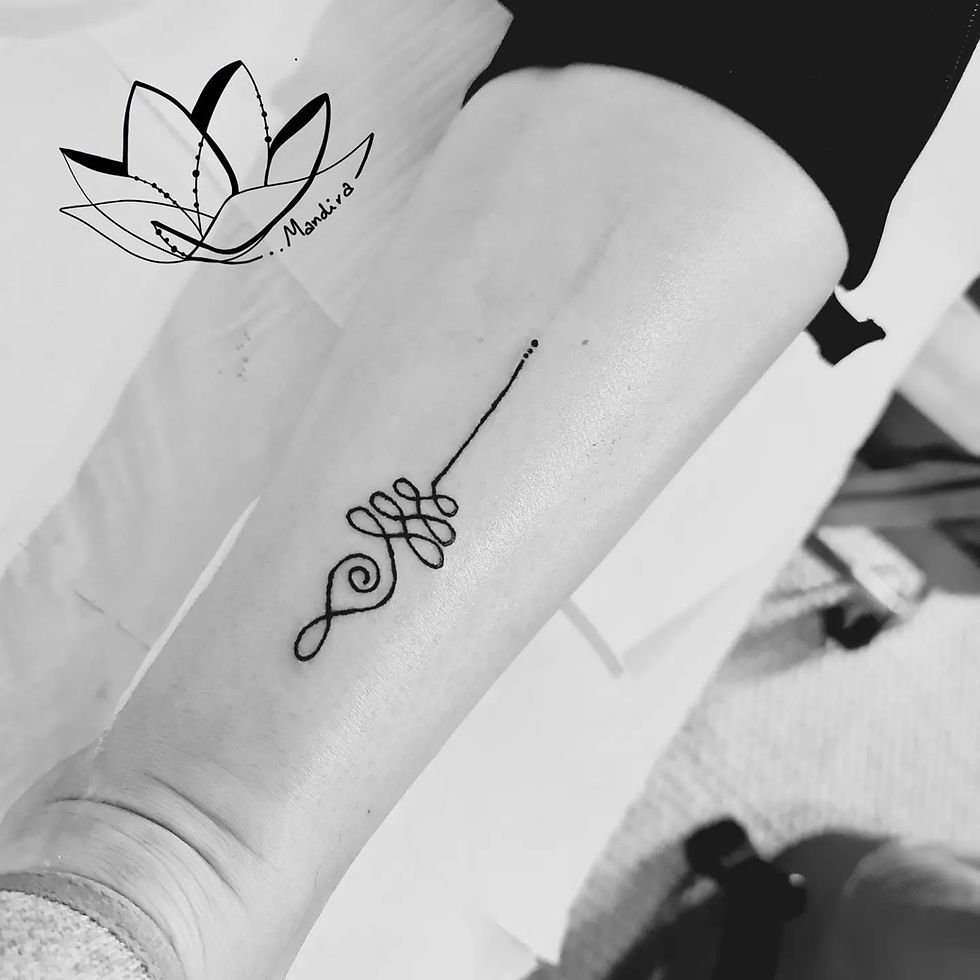 Unalome symbol black tattoo placed in the lower leg, lower calf, photo of the placement