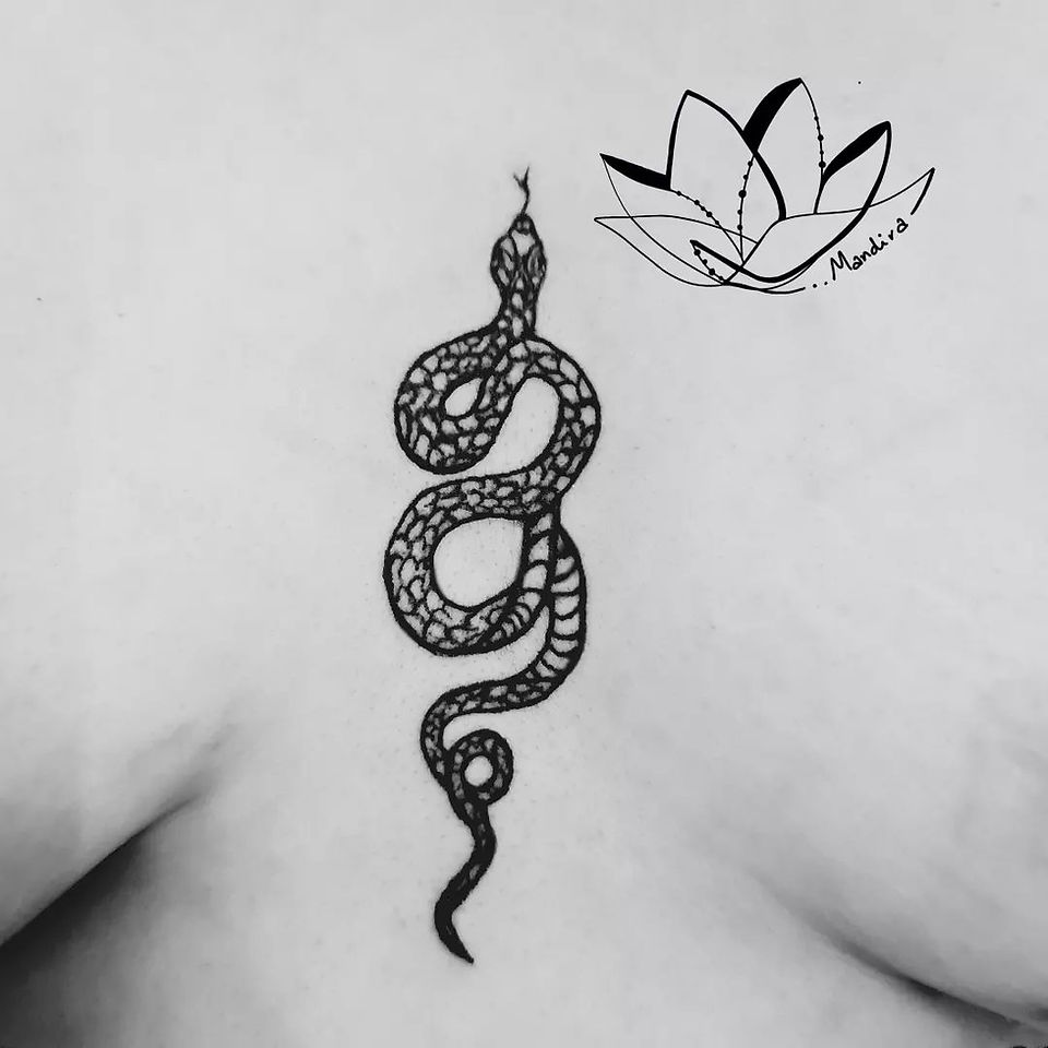 Snake sternum tattoo detail by Mandira Tattoo