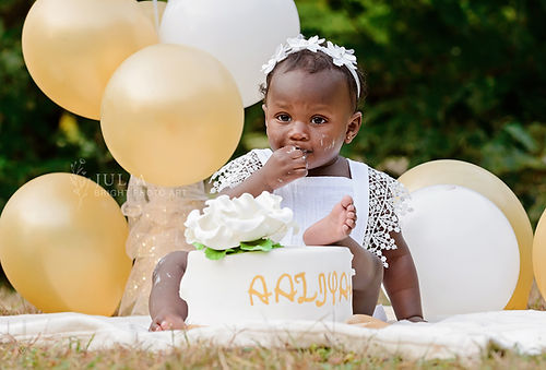 Adorable toddler smashing a colorful cake during a cake smash photoshoot in Toronto.