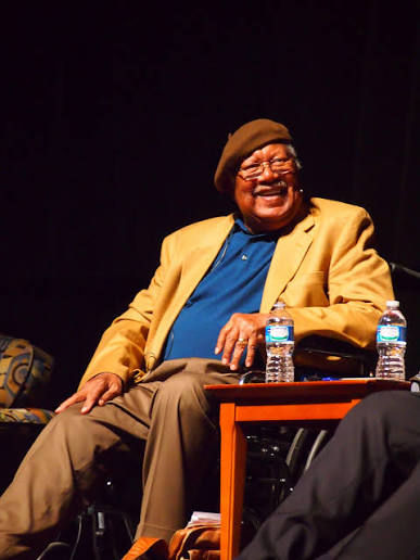Author Earnest Gaines in chair at symposium