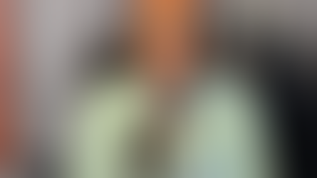 African American woman sitting in radio studio smiling while doing interview