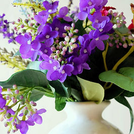 White vase with purple and white flower arrangement