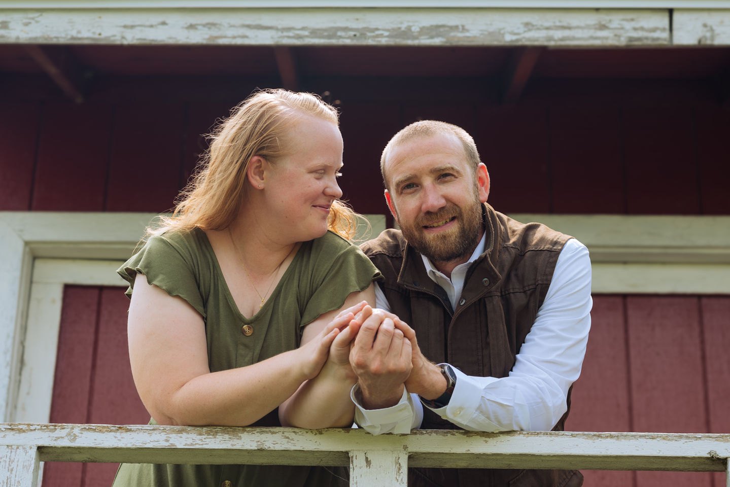 a man and a woman are holding hands and smiling