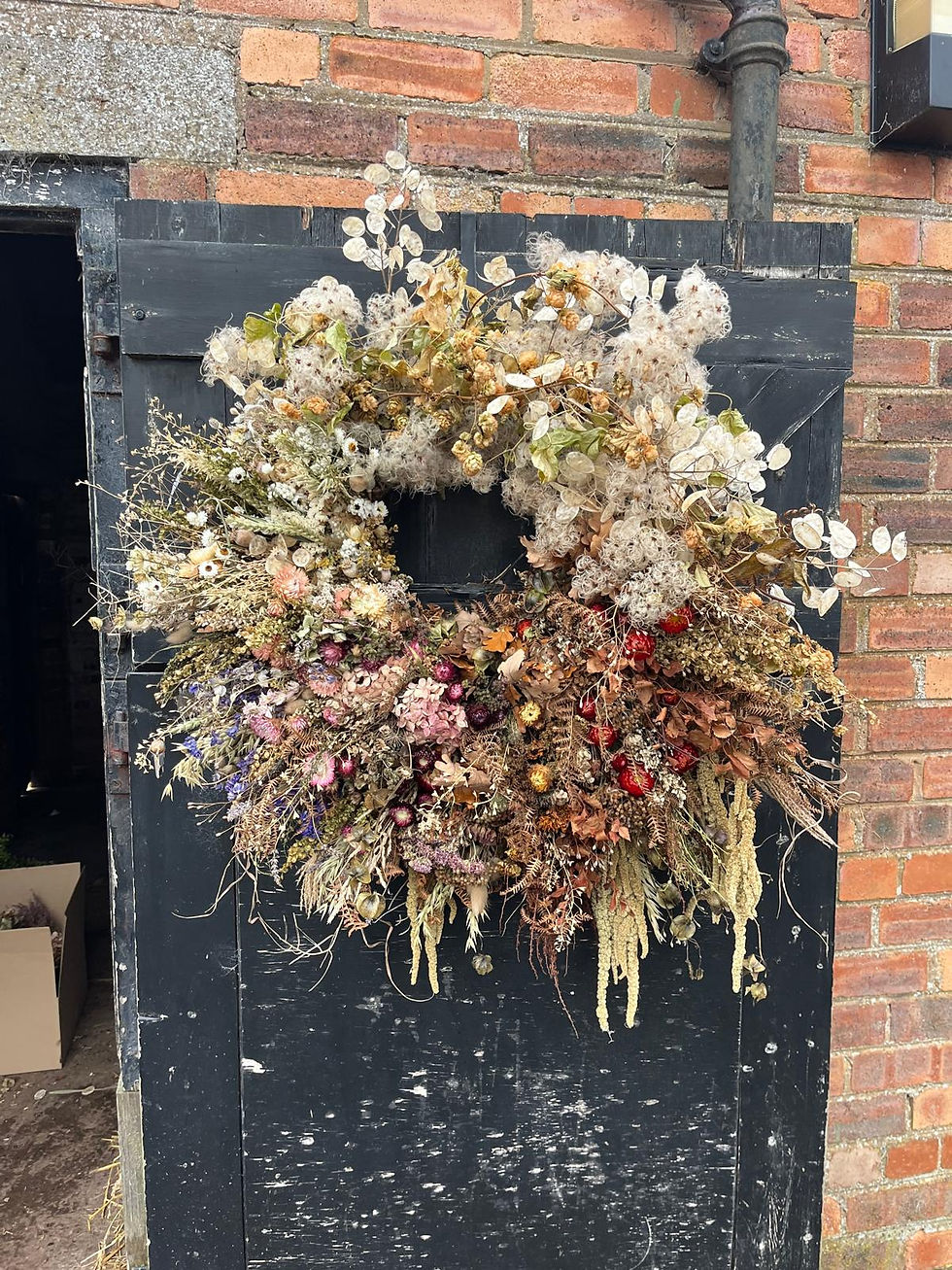 Colour‑blocked giant wreath — A giant colour‑blocked dried flower wreath made with farm‑grown blooms, grasses and seed pods,