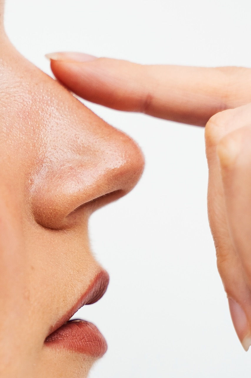 closeup-rhinoplasty-reshape-nose-improve-breathing-attractive-girl-touches-her-nose-before
