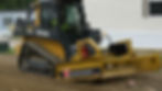 Regrading gravel driveway with a John Deere skid steer.