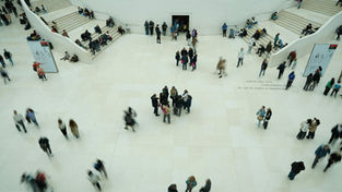 Visitors moving through a large exhibition hall for smart MICE event tracking and crowd insights analysis.