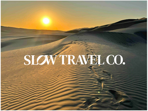 Desert at sunset with Slow Travel Co in text