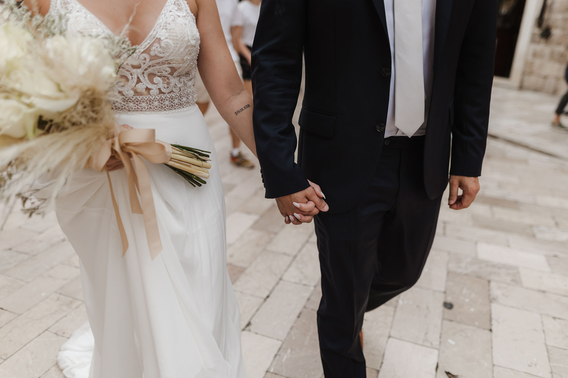 The bride and groom are walking along Stradun Street in Dubrovnik