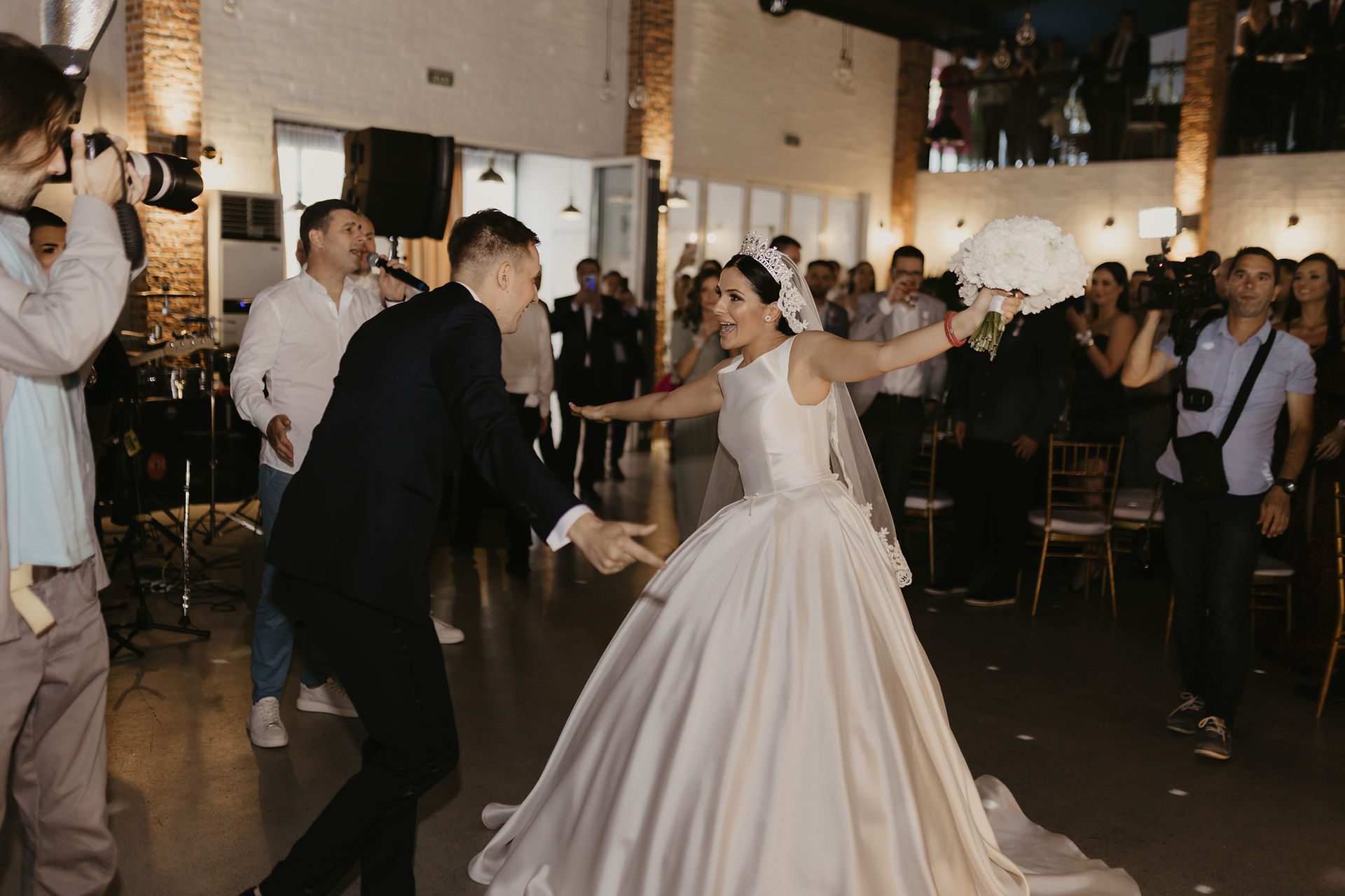 the bride and groom enter the wedding hall with music
