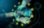 Hands typing on laptop with NIS2 hologram and EU stars overlay on digital blue background,