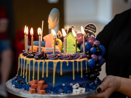 Birtday Event Photography: Birthday cake carried across the room.