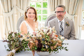 Bride and groom sitting for photographs after the wedding ceremony in Cardiff.