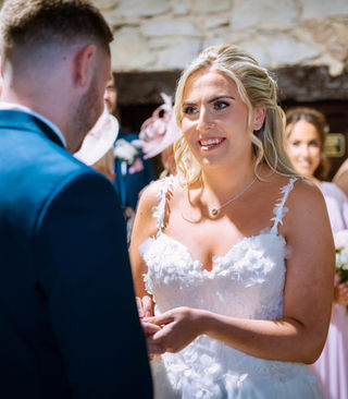 Bride and groom at their wedding ceremony in Pencoed House, Cardiff