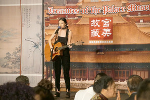 Jaq MacKenzie plays guitar on stage