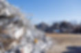 Image shows large scrap piles at their location in Hopkinsville, KY on various types of metal neatly piled 12' and higher. The ground which the piles lay on are clear dirt, and the sky above the piles is bright blue.