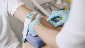 A nurse is taking blood from a patient