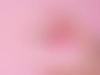 A hand wearing gloves holding a small Covid 19 vaccine bottle