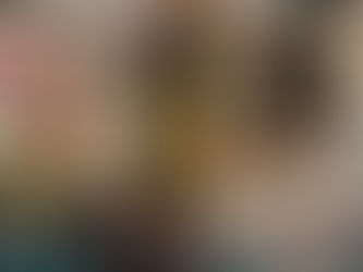 girl raises arms in triumph atop a slide 