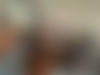 teens and adults gathered around a table of food.