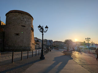 A medieval tower by a Marina at sunset