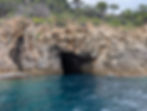 blue waters meet a sea cave entrance