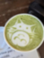 totoro etched into a green foam latte