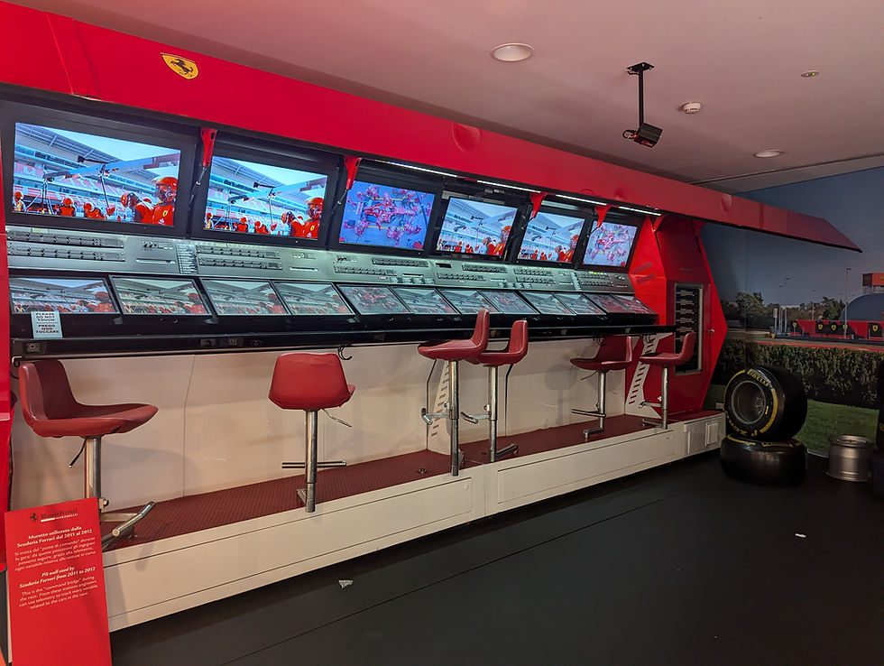 red pit wall with screens and seats