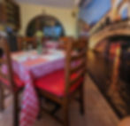 red checkered tablecloth table with a mural of the pontevecchio
