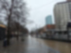 a tram stop along a rainy street
