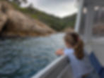 girl looks from a boat to the sea