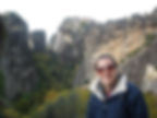 woman in front of rock structure