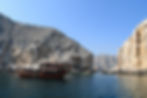 dhow boat in front of fjord inlet