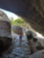 girl walks between rocks