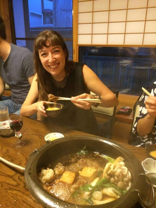 Dipping beef in raw egg with a hot pot of flavors