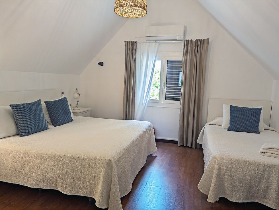 a white hotel room with two beds