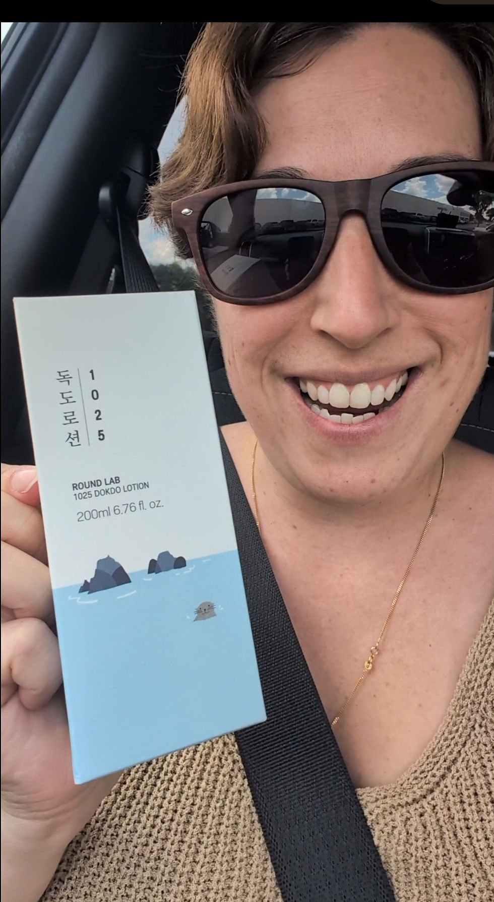 a woman shows off a new Korean skin lotion