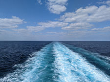 the trail of water behind a cruise ship