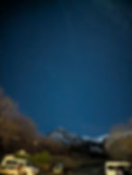 starry sky above a mountain peak